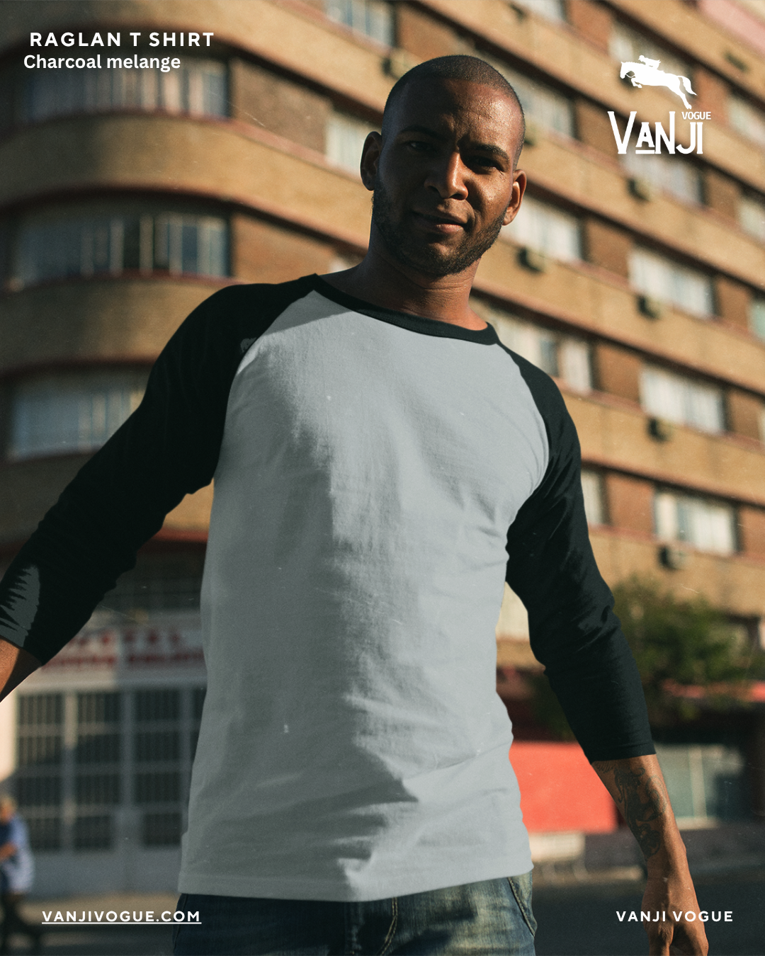 Man wearing a premium raglan t shirt with charcoal melange body and black sleeves outdoors 1