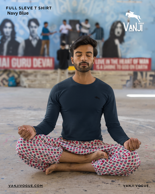 Men's full sleeve t shirt in navy blue worn by a man meditating outdoors in a relaxed pose