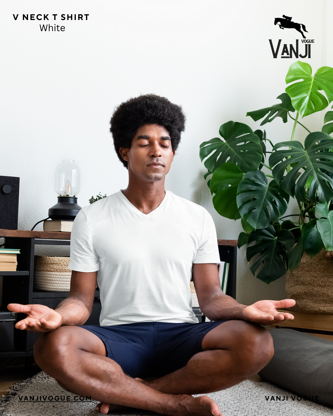 Man meditating indoors wearing a white v neck t shirt for men by Qikink with casual navy shorts