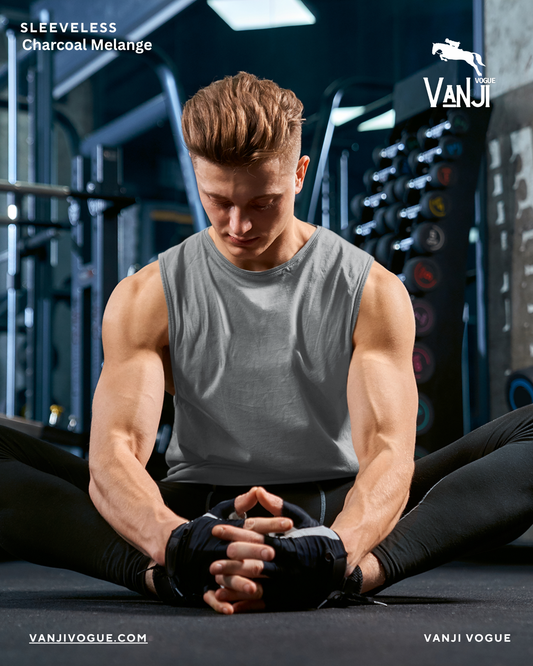 Fit man wearing a workout sleeveless shirt for men in charcoal melange exercising in a gym